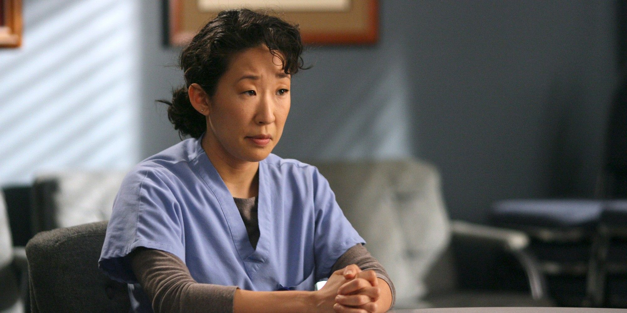Cristina Yang with her hands together looking serious in Grey's Anatomy