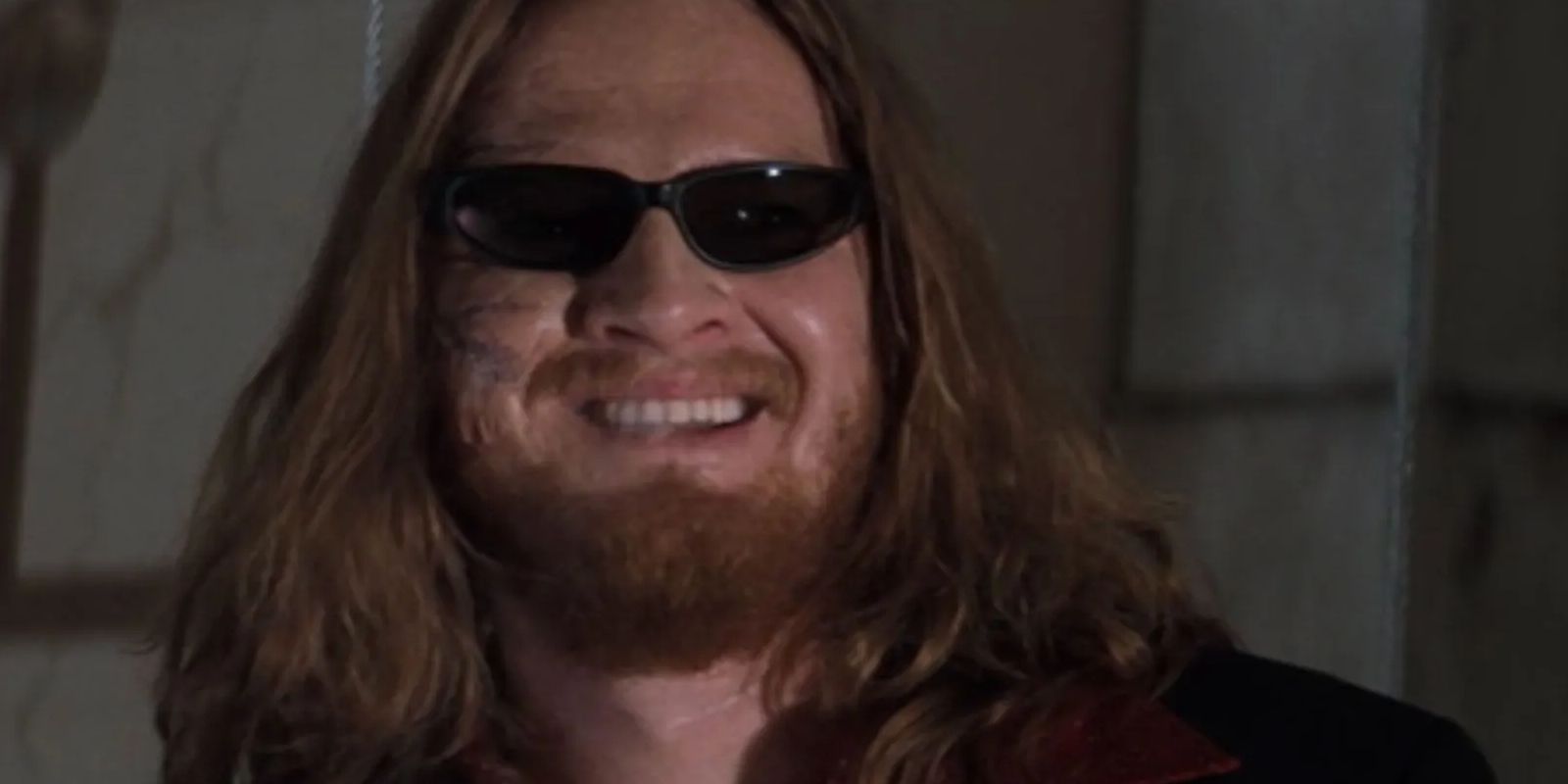 Donal Logue as Scud smiling with sunglasses on