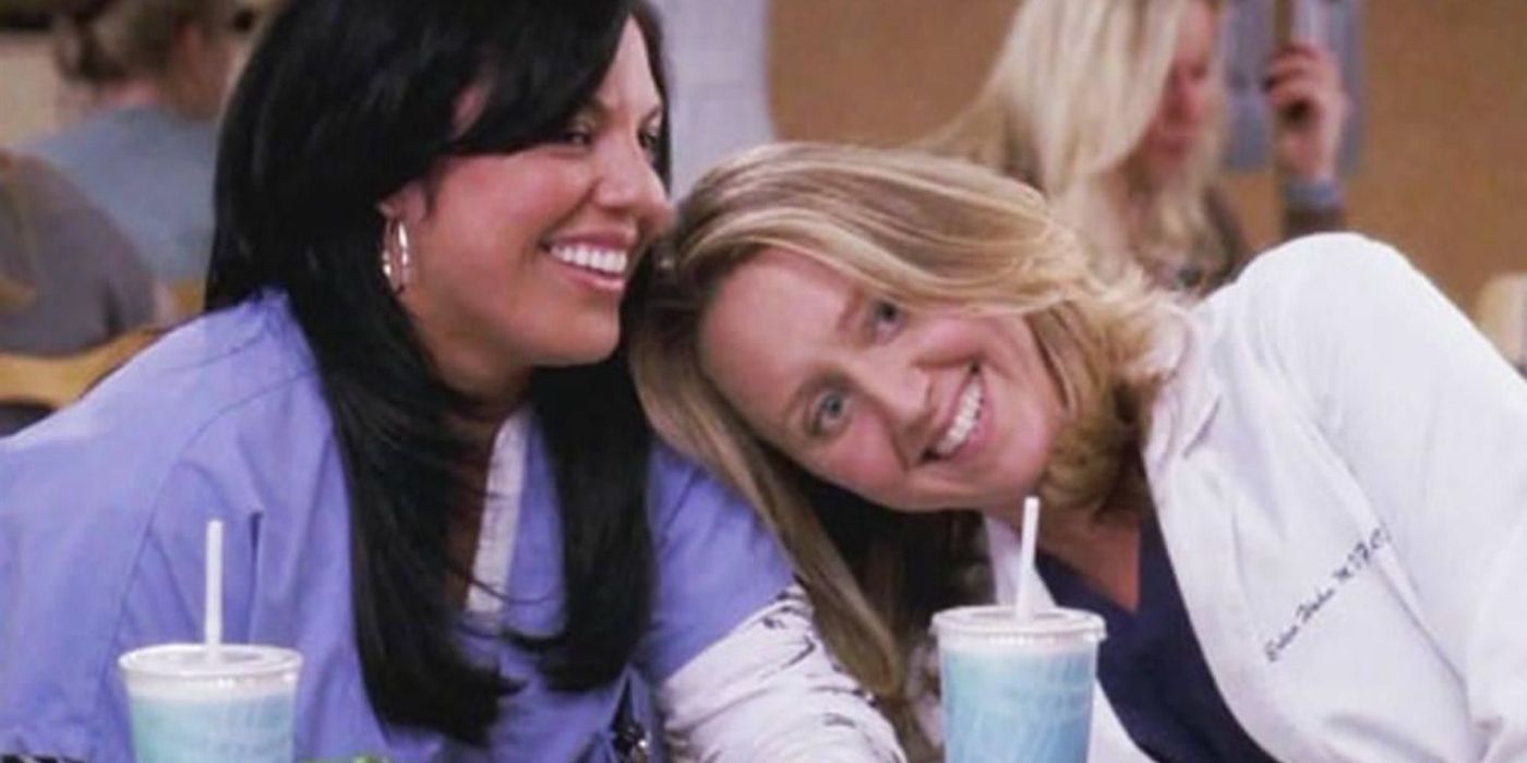 Erica Hahn leaning her head on Callie's shoulder in the cafeteria at Seattle Grace Hospital