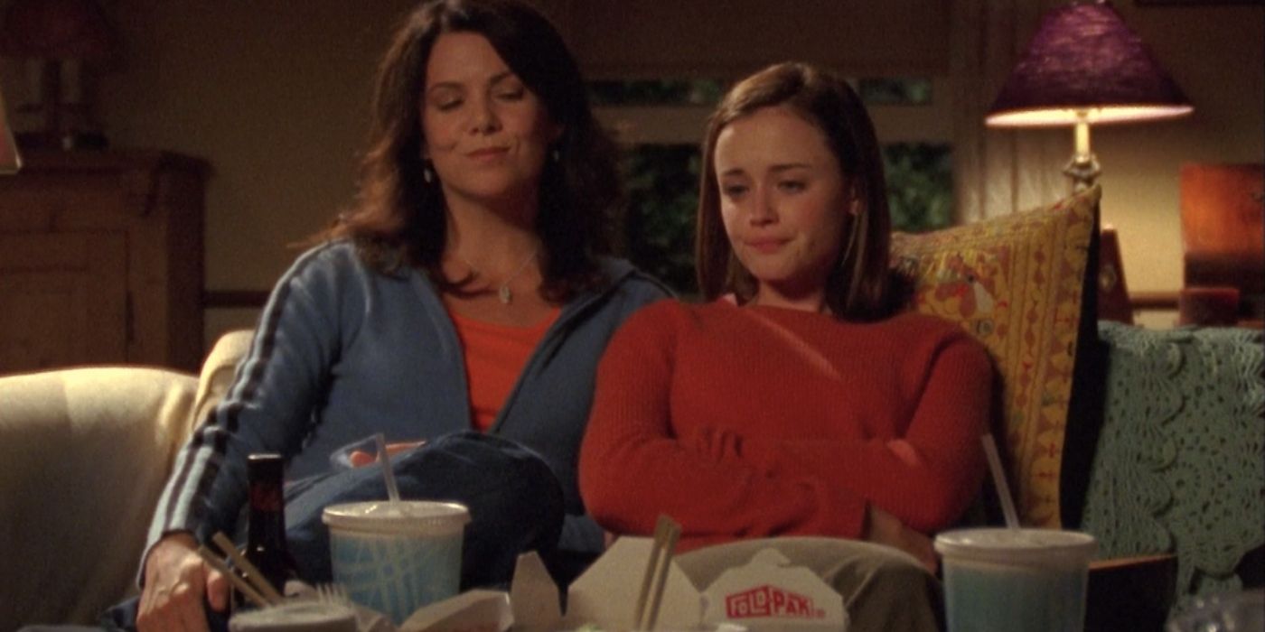Lorelai and Rory sitting on the couch watching a movie on Gilmore Girls