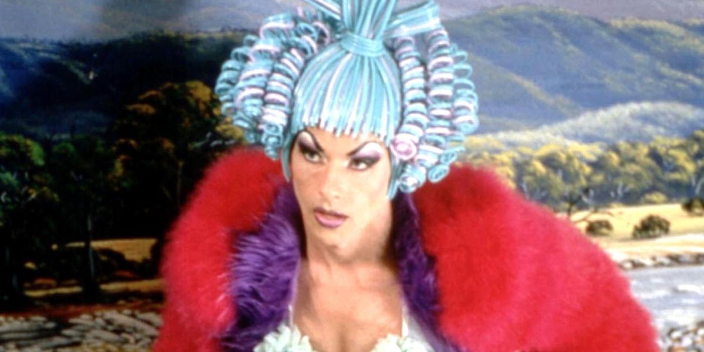Guy Pearce in full drag against a picturesque outdoor background in The Adventures of Priscilla, Queen of the Desert