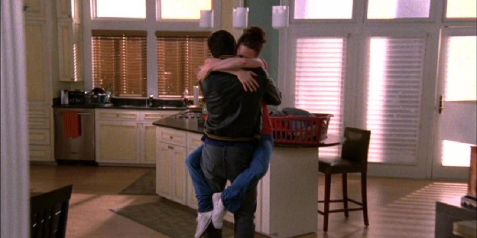 Haley James Scott hugs Nathan Scott in their kitchen in One Tree Hill