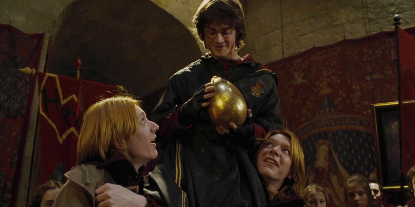 Harry sits on Fred and George's shoulders with the Golden Egg