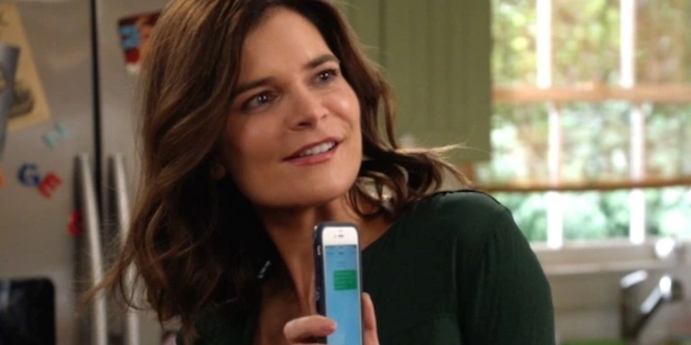 Heather holding up a phone on Life In Pieces