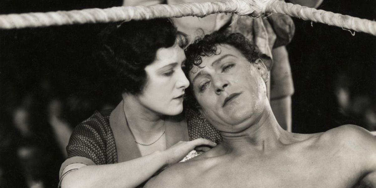 A boxer sits in the corner of the ring and is comforted by a woman from The Ring 