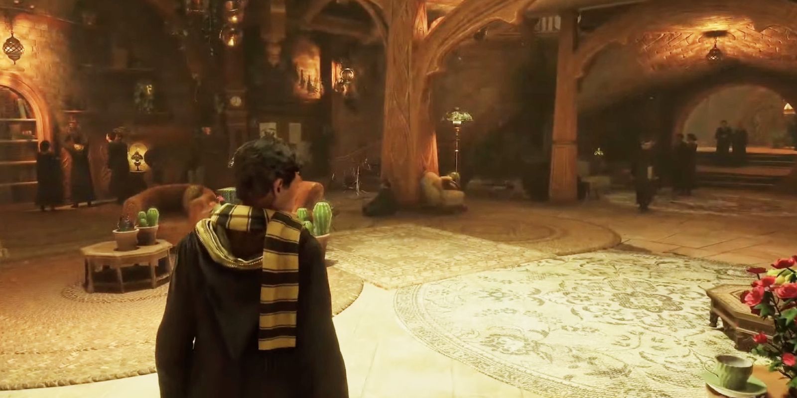 Student in Hogwarts Legacy walks through the Hufflepuff common room