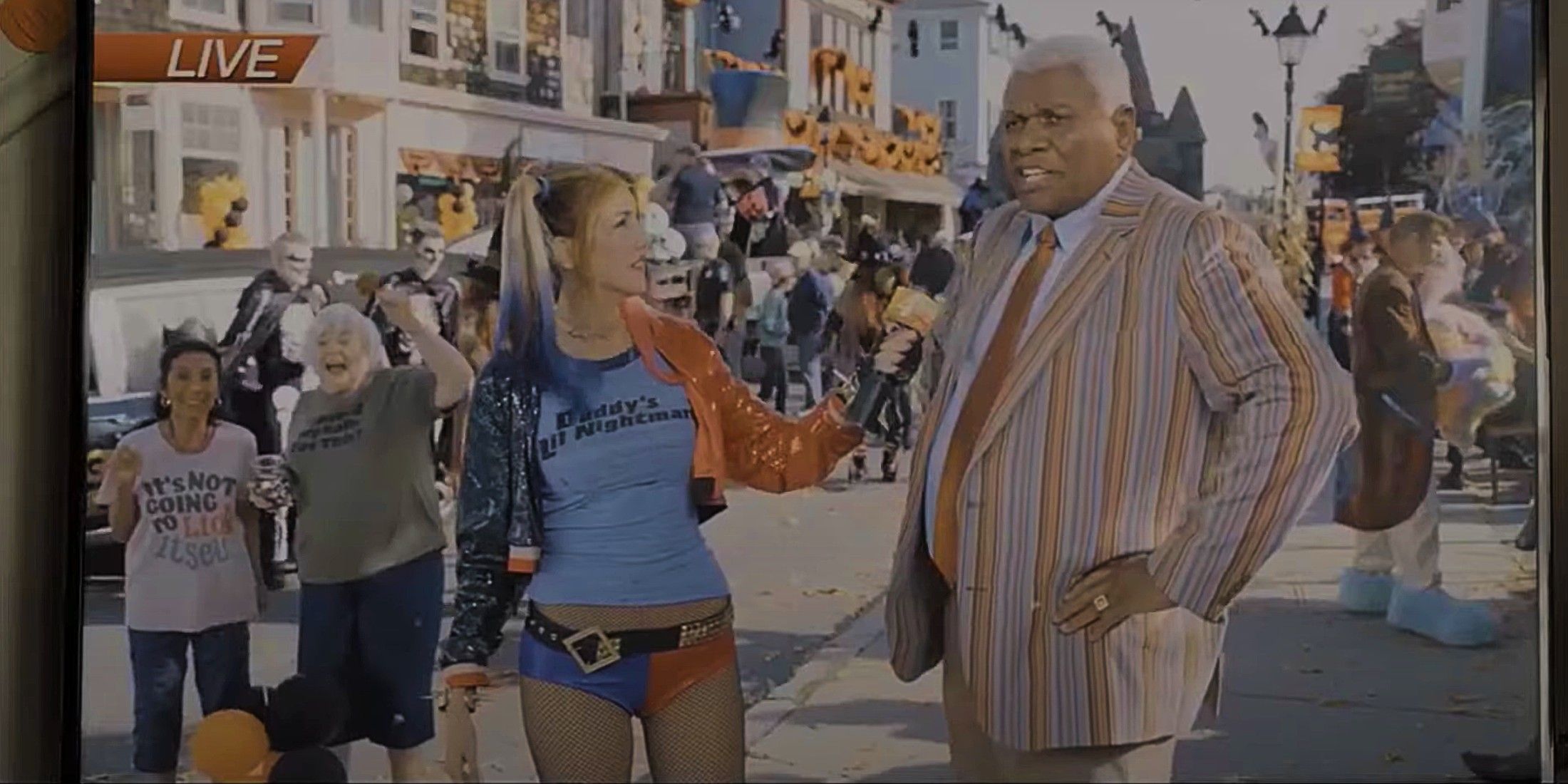 Jackie Sandler interviewing George Wallace dressed as Harley Quinn in Hubie Halloween 