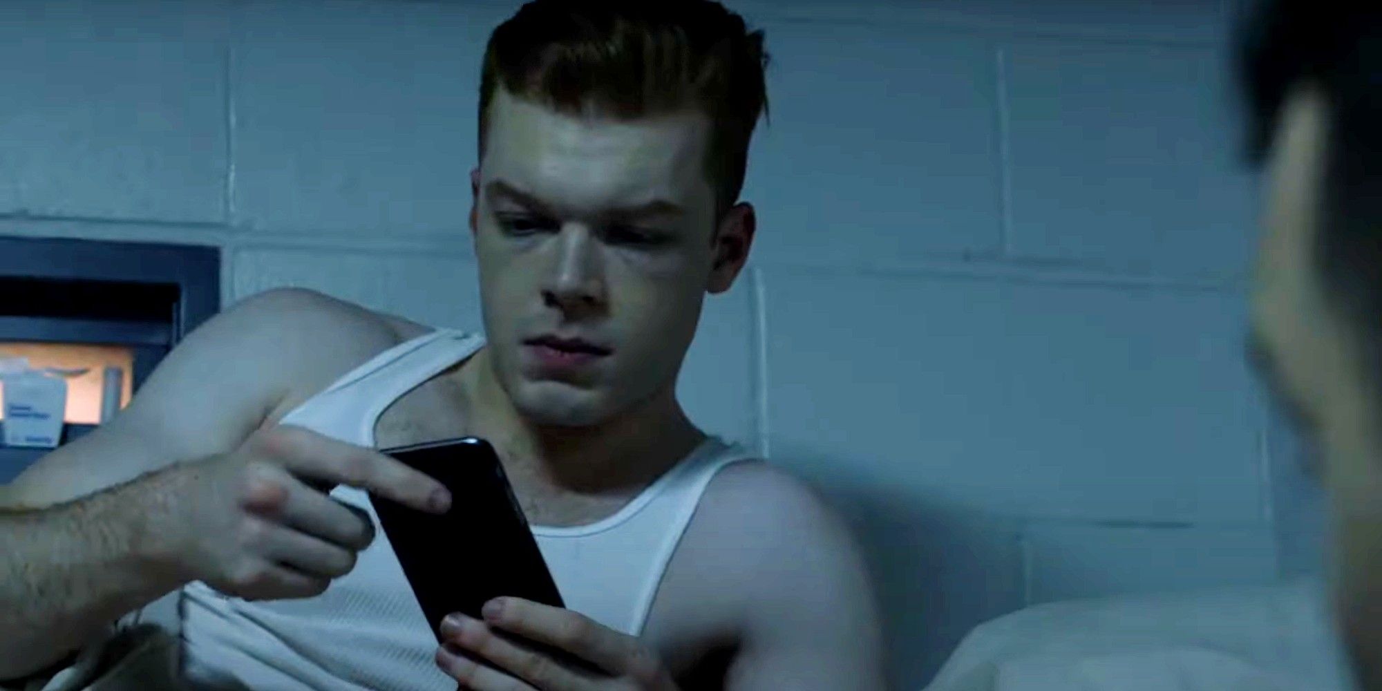 Ian Gallagher with phone in prison