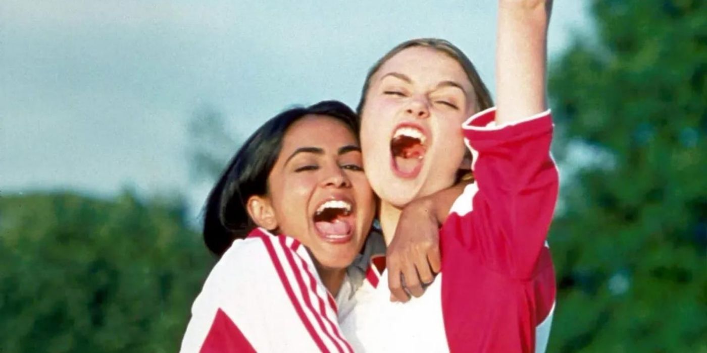 Jesminder and Jules celebrating by hugging and Jules pumping her fist in the air in Bend It Like Beckham