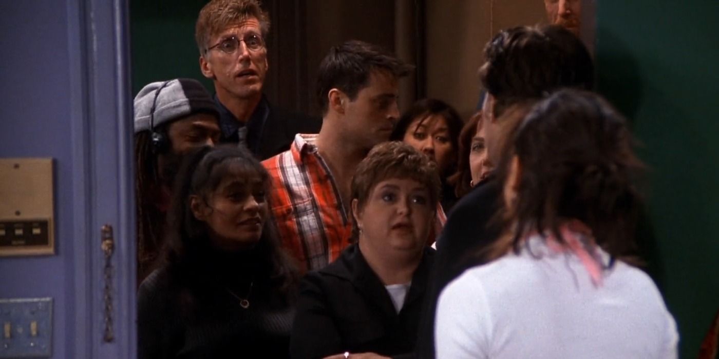 Joey and the neighbors talk to Monica and Chandler outside their door in Friends