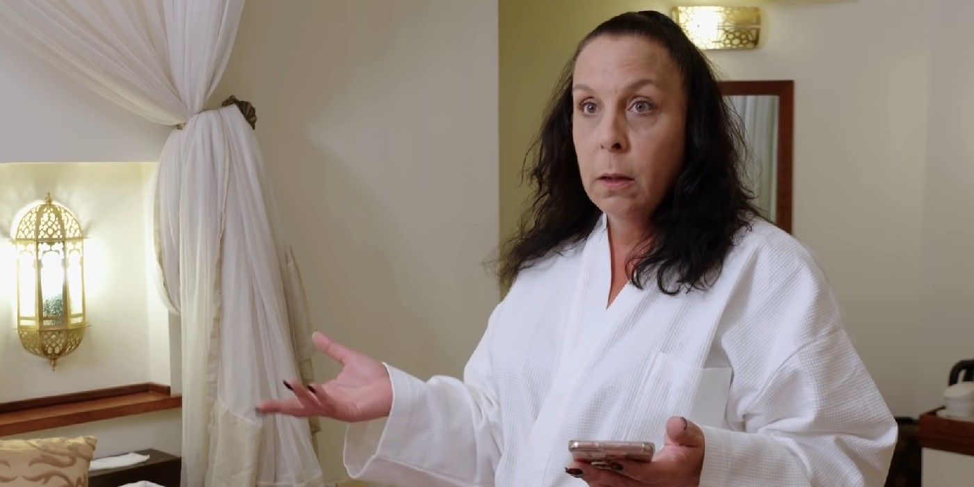 Kim Menzies 90 Day Fiancé wearing bathrobe gesturing with hands