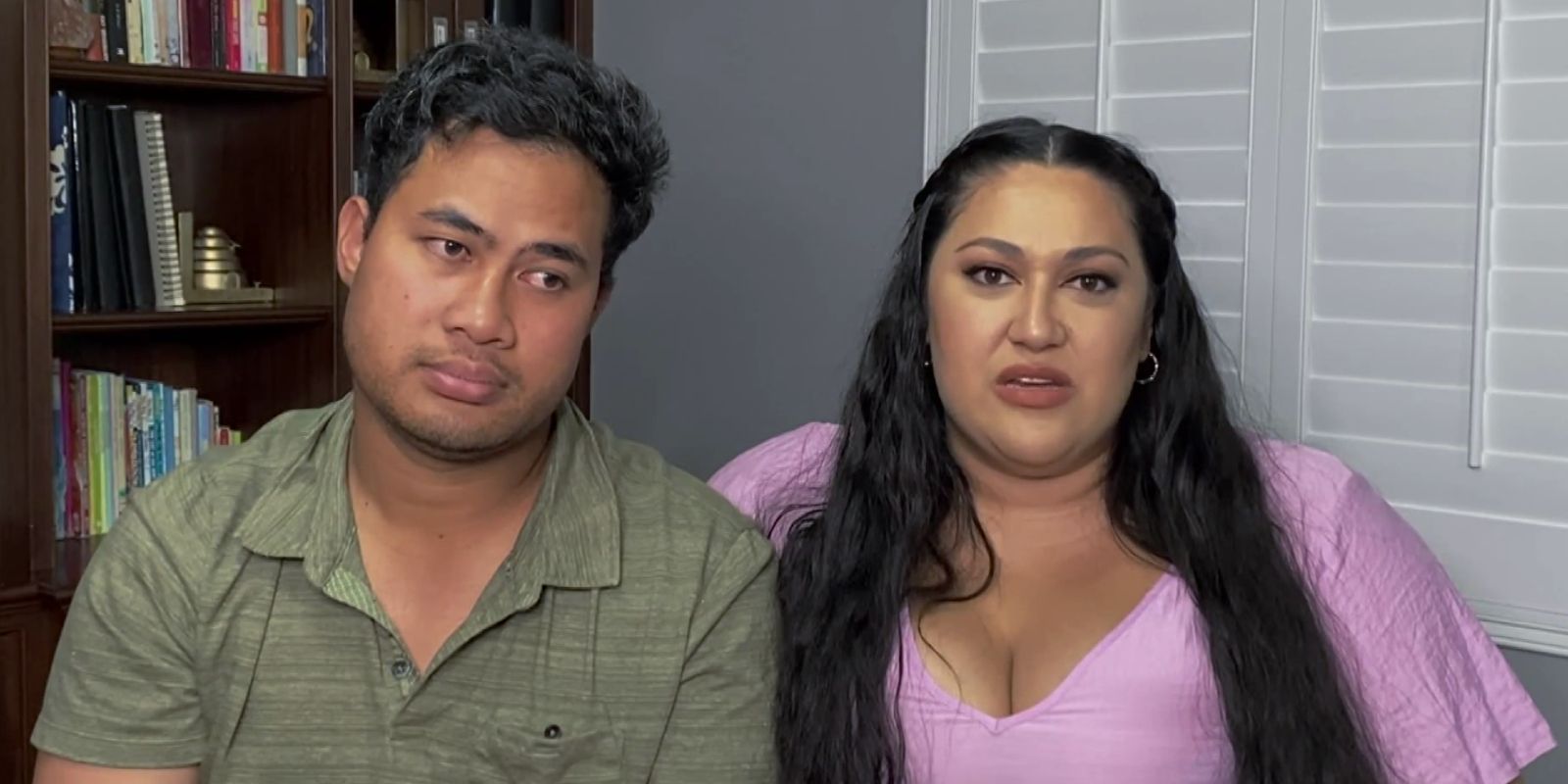 Kalani Faagata in a pink dress and Asuelu Pulaa in a green shirt from 90 Day Fiance sitting together
