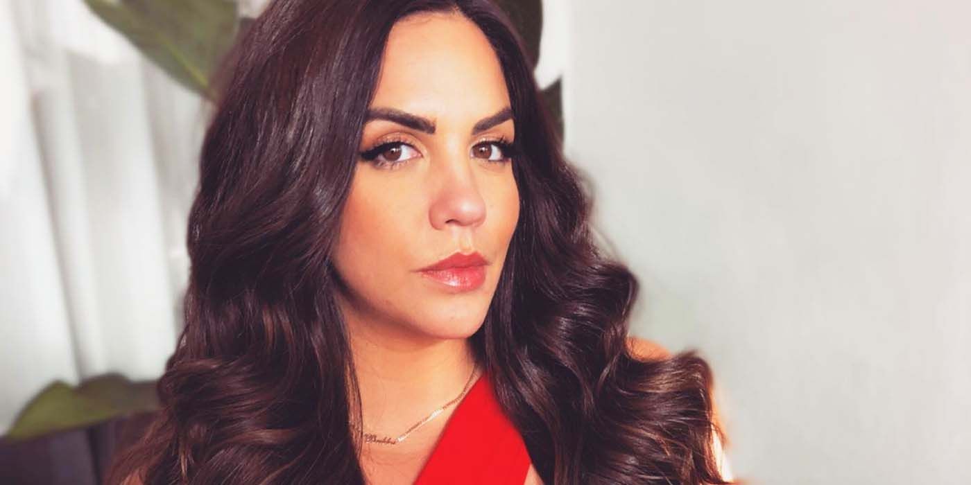 Katie Maloney from Vanderpump Rules wearing red with long hair serious expression