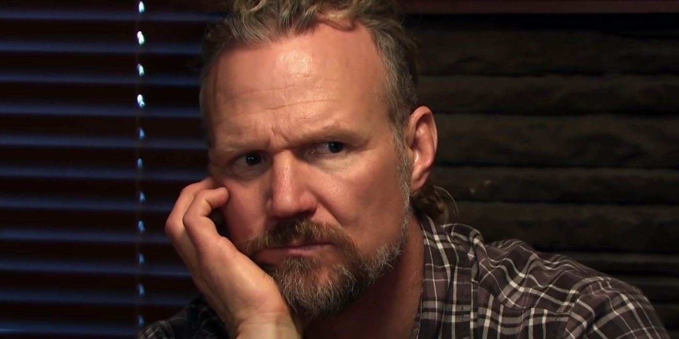 Kody Brown in Sister Wives looking pensive in a close up with hand on face