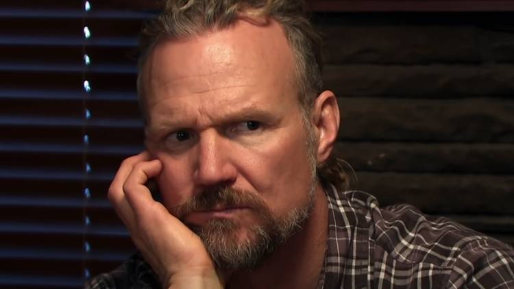 Kody Brown in Sister Wives looking pensive in a close up with hand on face
