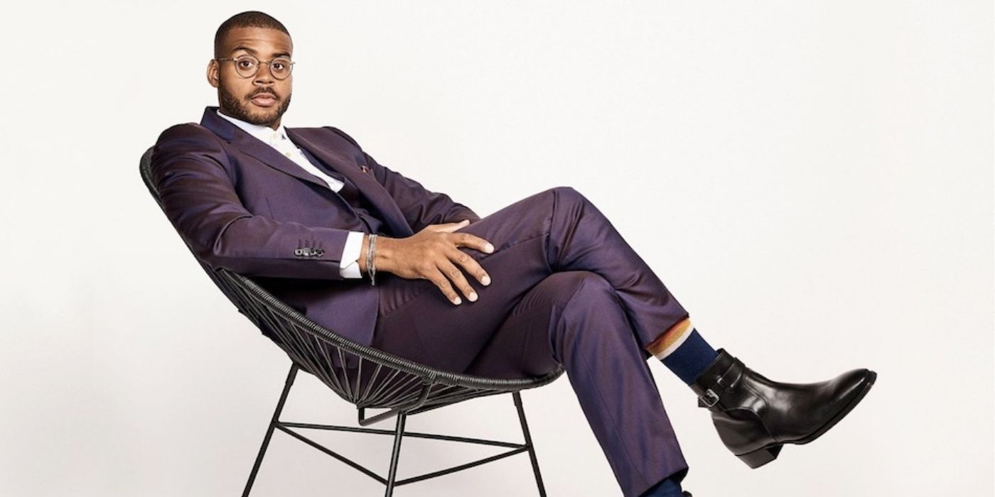 Kris Bowers sitting on a chair and looking at the camera