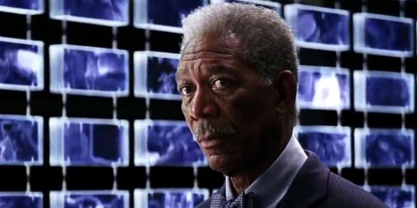 Lucius Fox standing in front of monitors in The Dark Knight