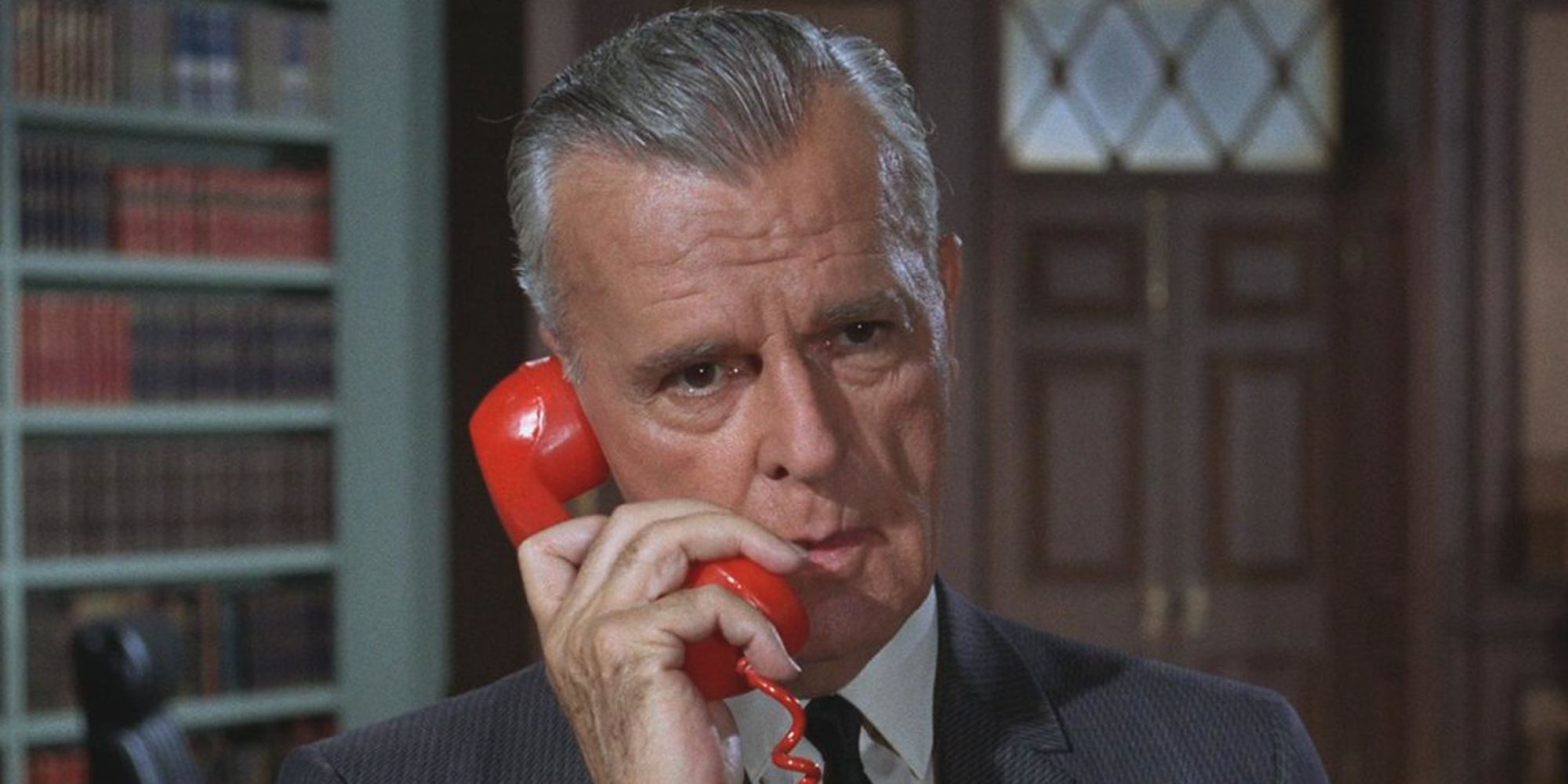 Neil Hamilton as Commissioner Jim Gordon calling Batman via the red Bat phone in the 1966 series