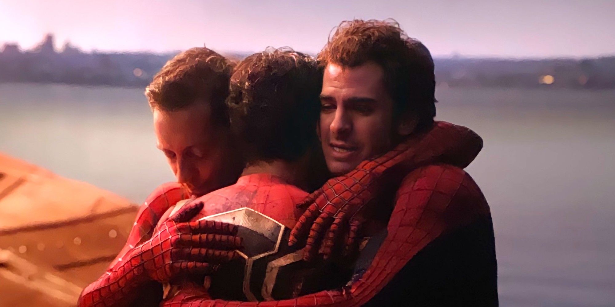 The three Spider-Men hug in Spider-Man: No Way Home.