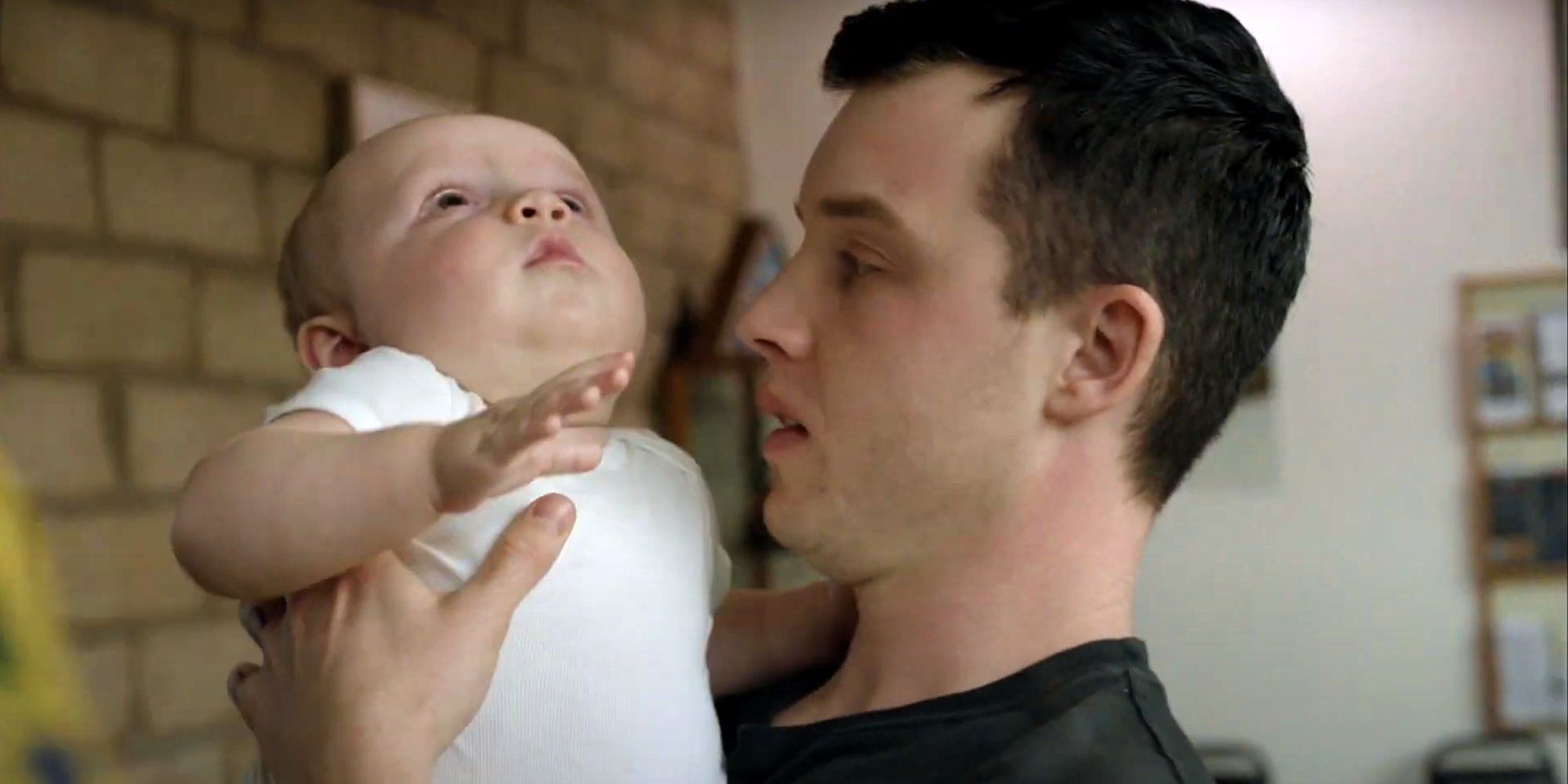 Noel Fisher as Mickey Milkovich holding Yevgeny in Shameless
