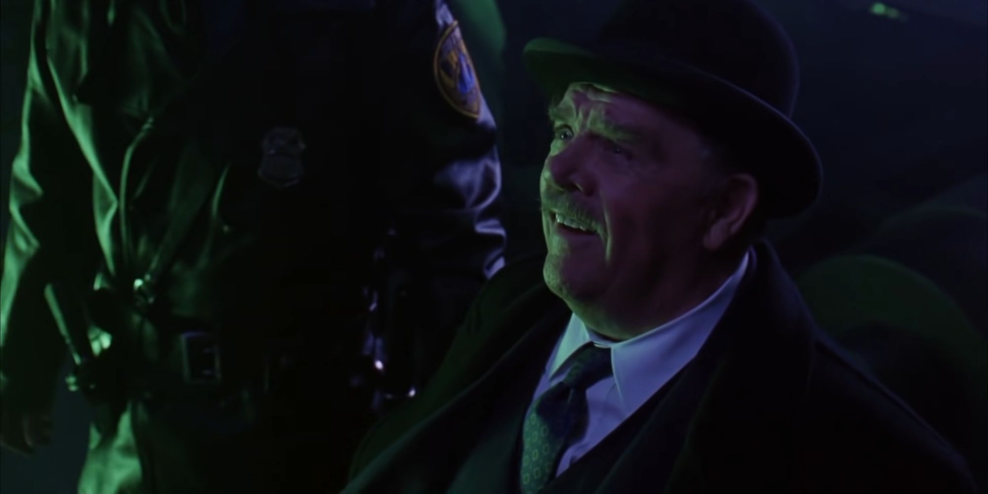Pat Hingle as Commissioner Jim Gordon smiling at the arrival of Batman in the Batwing in Batman Forever