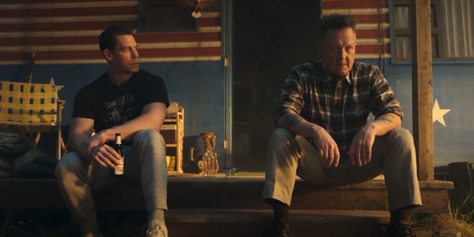 Peacemaker Episode 8 Its Cow or Never scene of John Cena as Christopher Smith and Robert Patrick as Auggie Smith sat next to each other