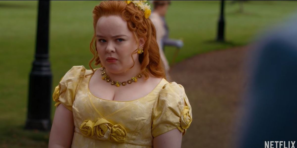 Penelope Featherington wearing a yellow dress and looking angrily at Colin in Bridgerton season 2