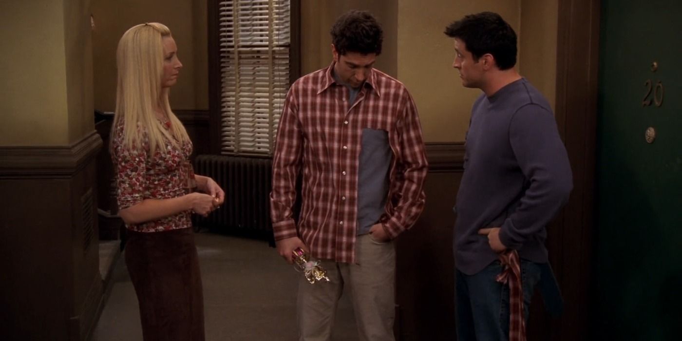 Phoebe Ross and Joey standing in Monica's hallway in Friends