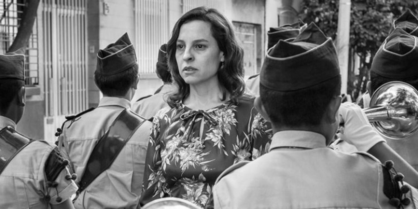 Sofia walking down a street full of soldiers in Roma