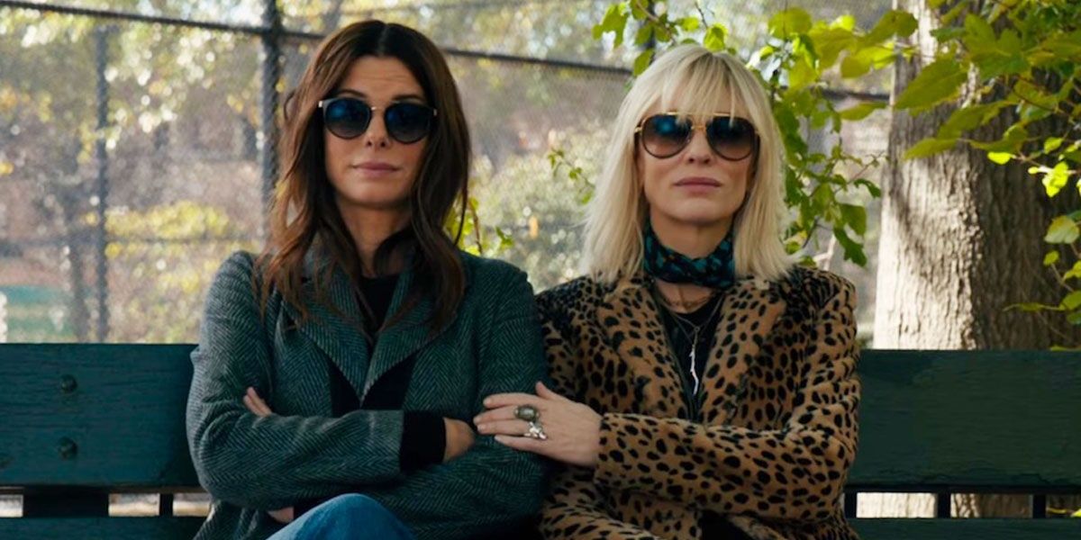 Sandra Bullock and Cate Blanchett sitting in a park in Oceans 8 Cropped