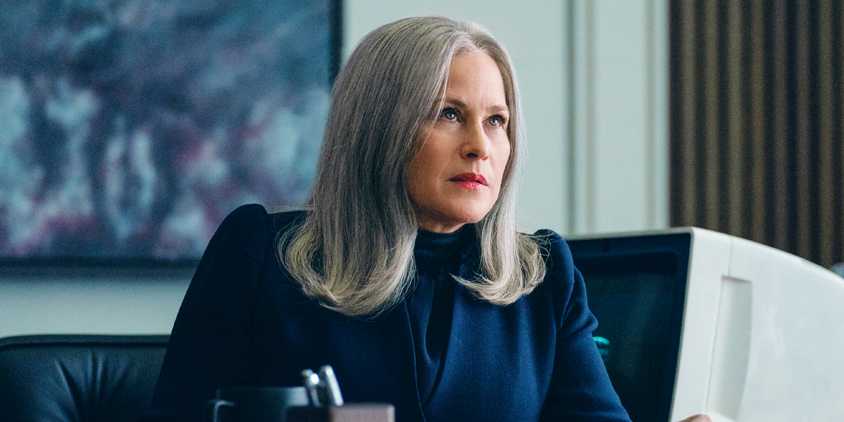 Patricia Arquette as Ms. Cobel sitting behind her desk in Severance 