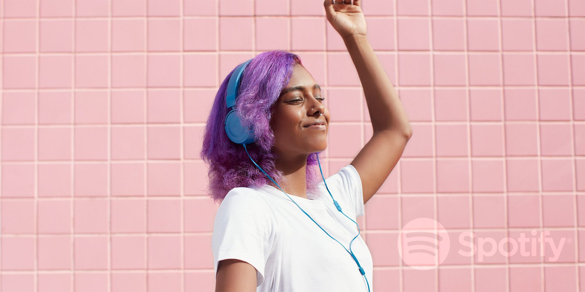 Girl listening to Spotify with blue headphones