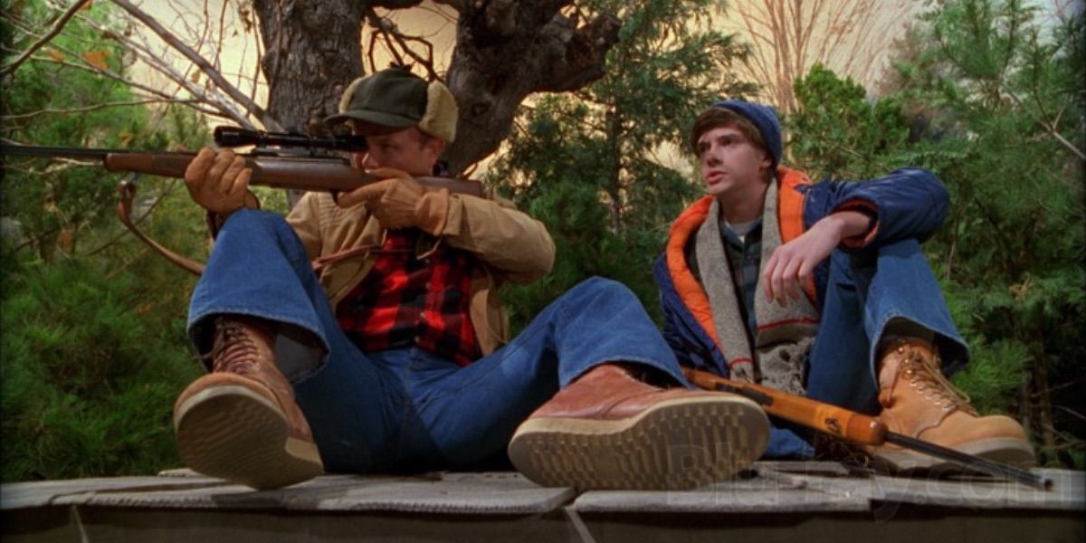 Red aims his rifle while Eric looks on from That 70s Show