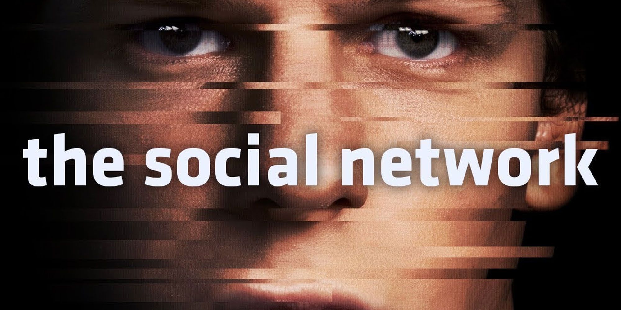 Jesse Eisenberg face stares out from the poster for The Social Network.