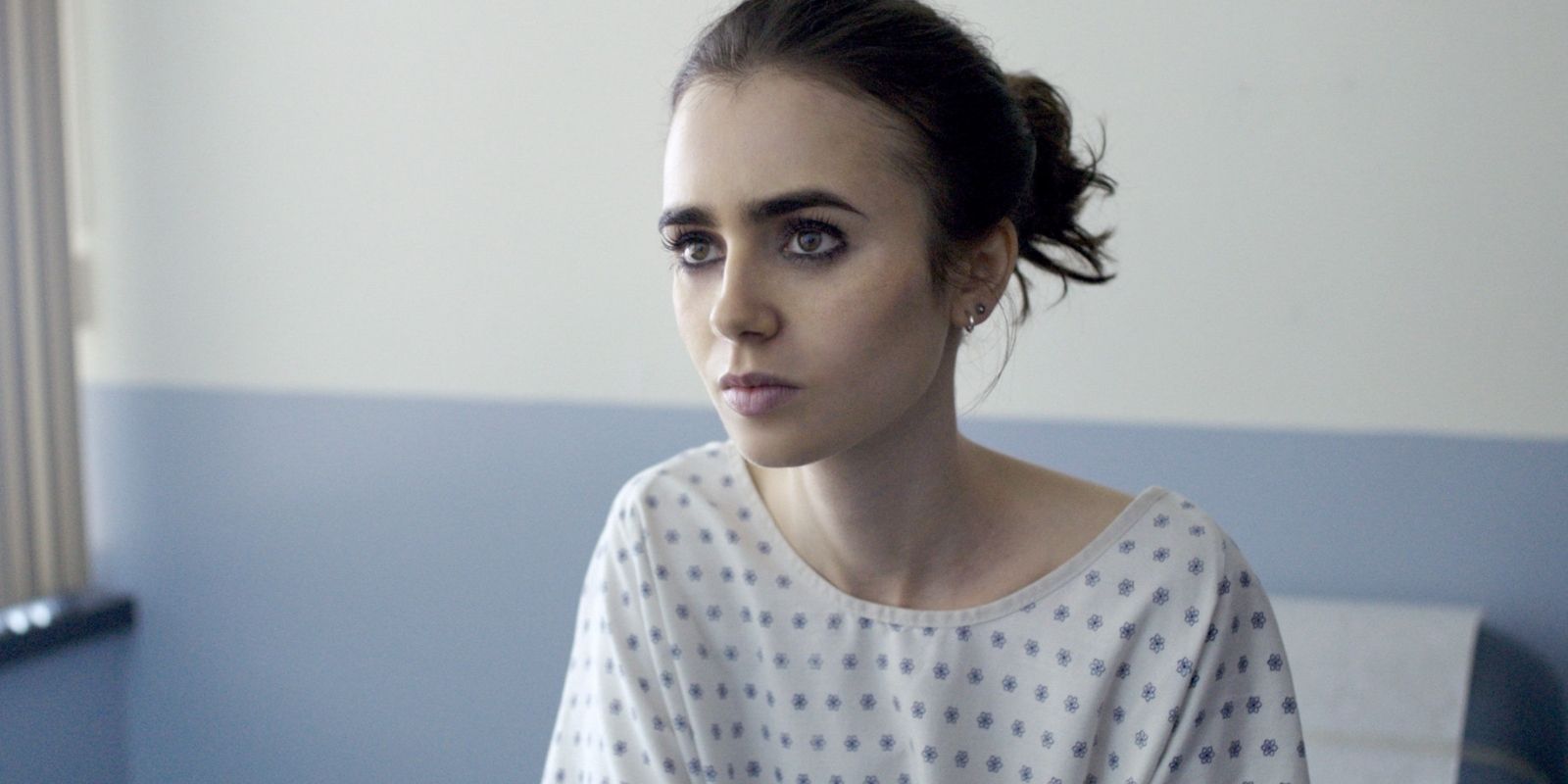 Lily Collins sitting in a doctors office in To The Bone.
