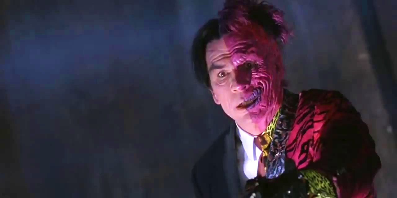 Two-Face prepares to execute a bank security guard in Batman Forever