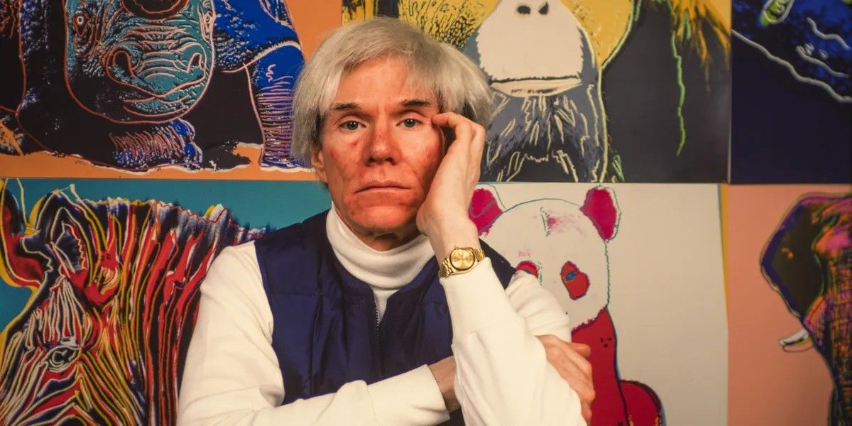 Andy Warhol in front of colorfully painted animals