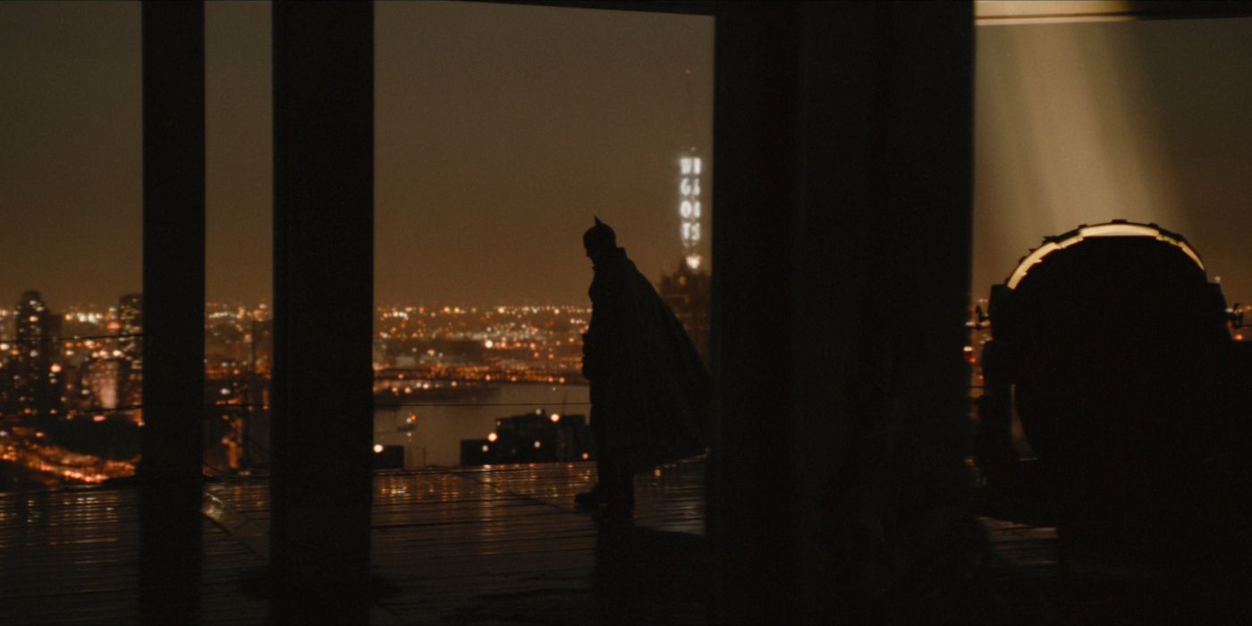 Batman standing against Gotham's skyline in The Batman