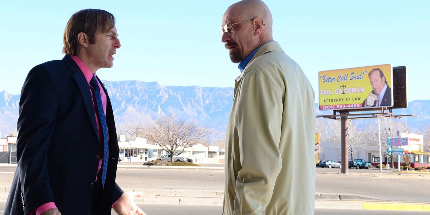 Saul and Walter White face to face in a scene from Breaking Bad, Saul's billboard in the background.