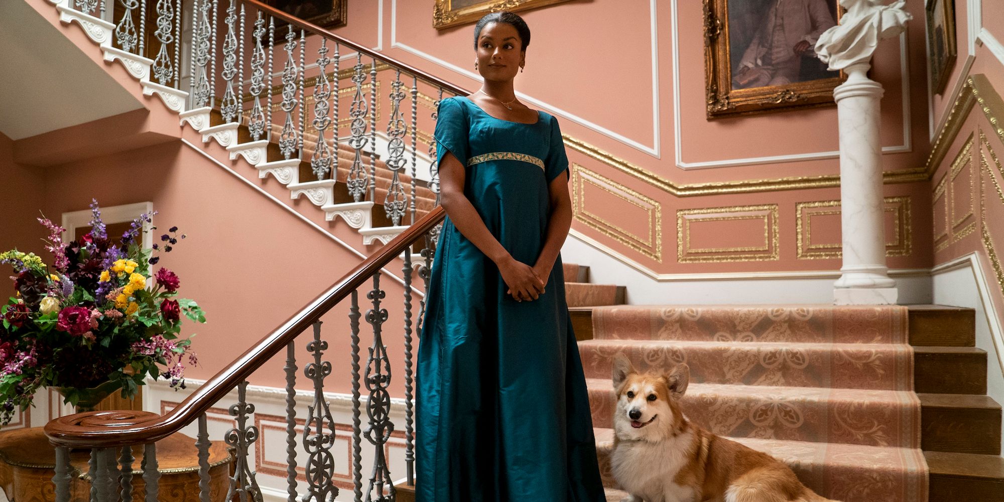 Kate Sharma stands on the stairs with her dog in Bridgerton Season 2