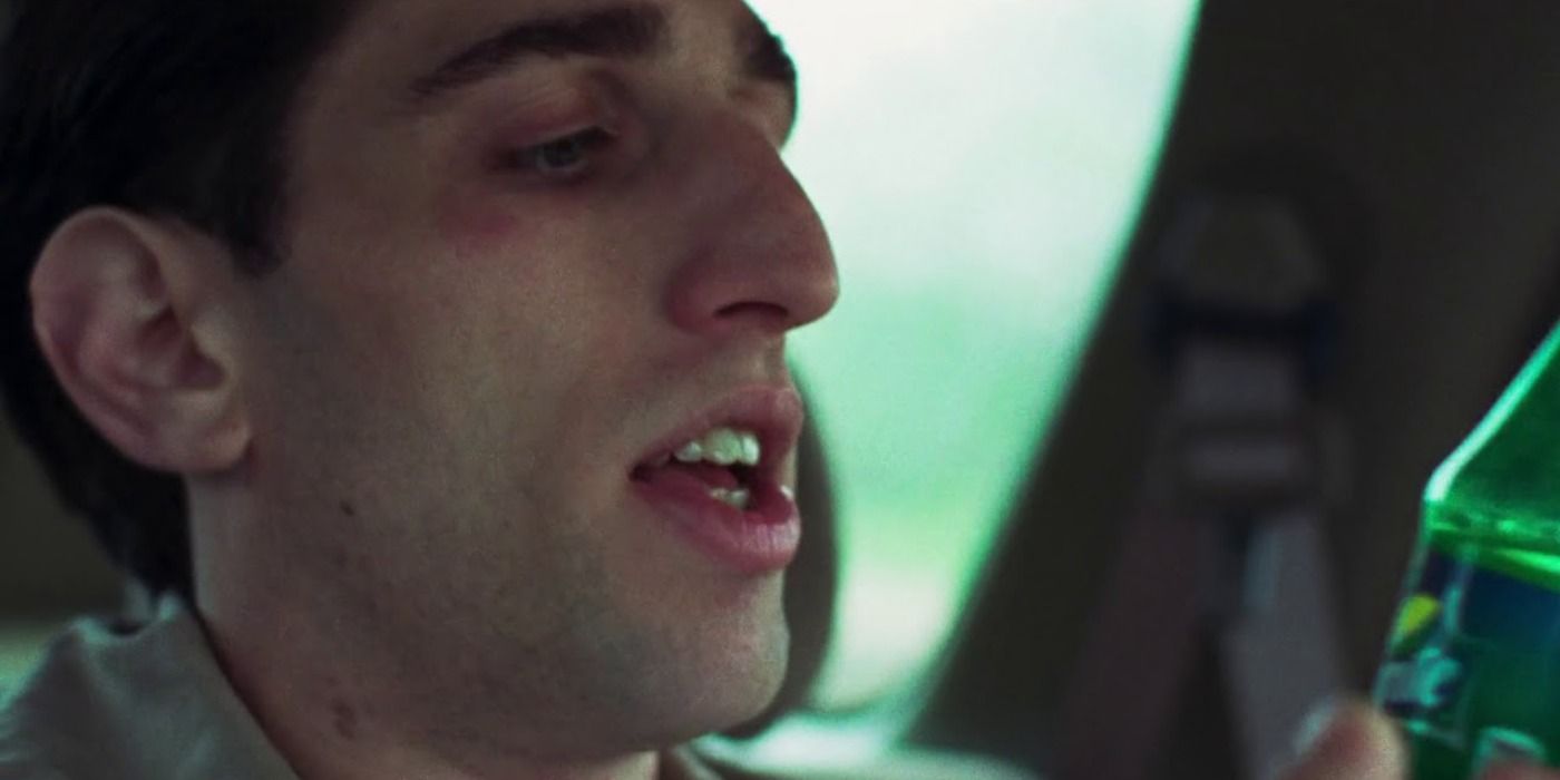 Buddy Duress looking at a sprite bottle in Good Time.