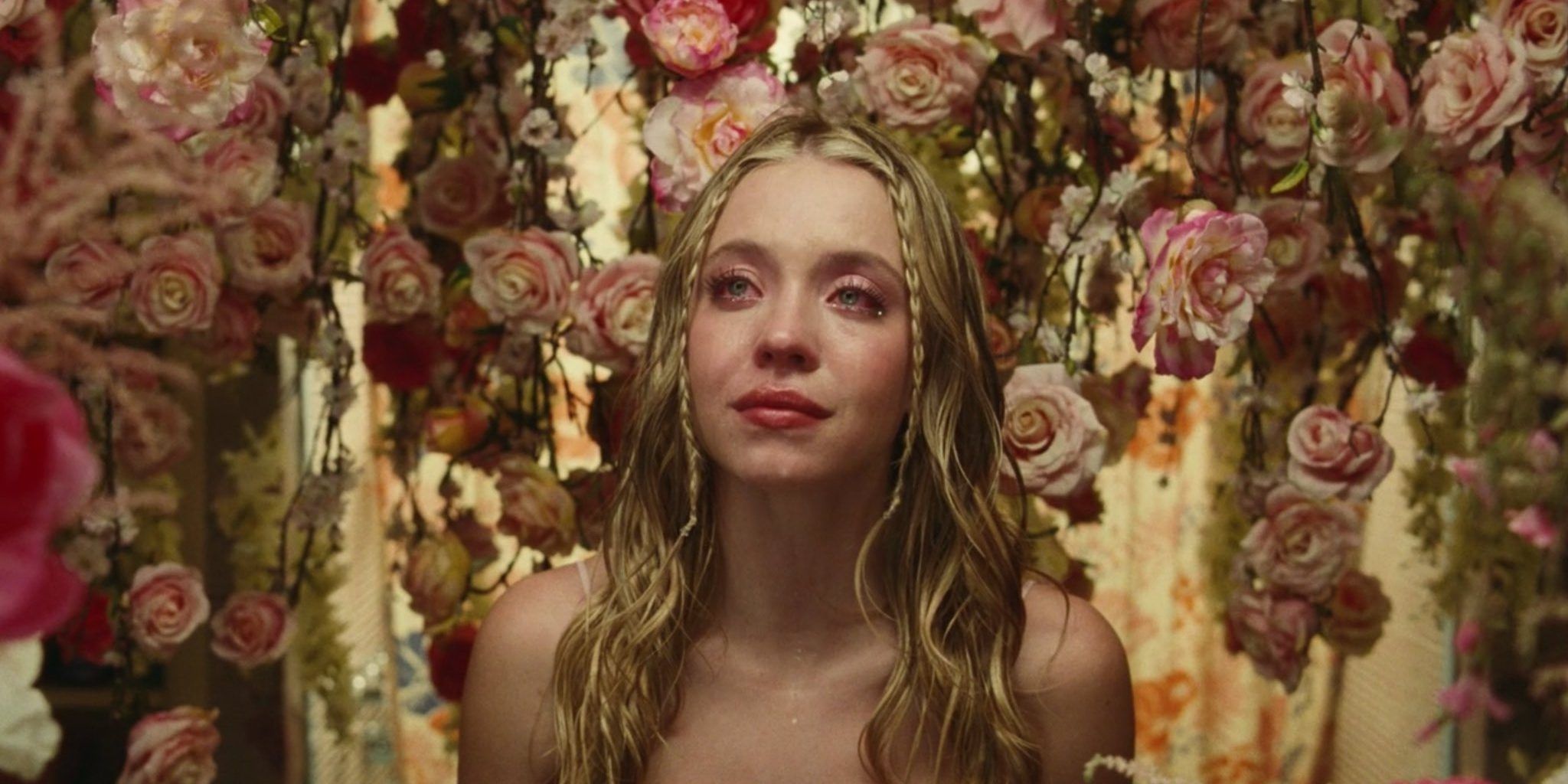 Cassie crying, surrounded by flowers on Euphoria