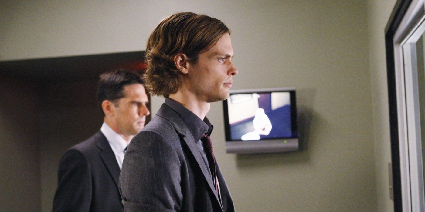Dr Reid looking through glass into an interrogation room