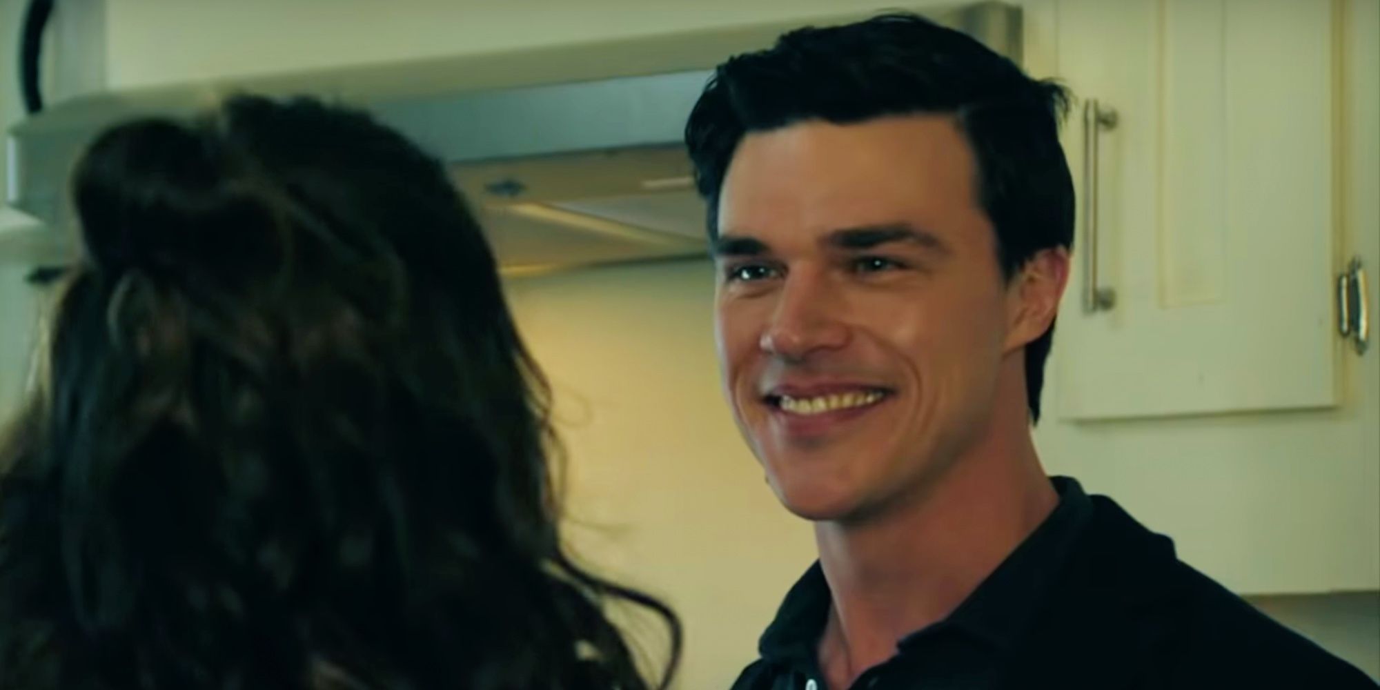 Finn Wittrock as Tony smiling at Milinda in the kitchen in Deep Water.