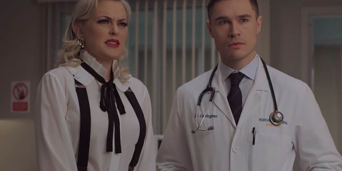 Alexis and Adam standing together in the hospital on Dynasty.