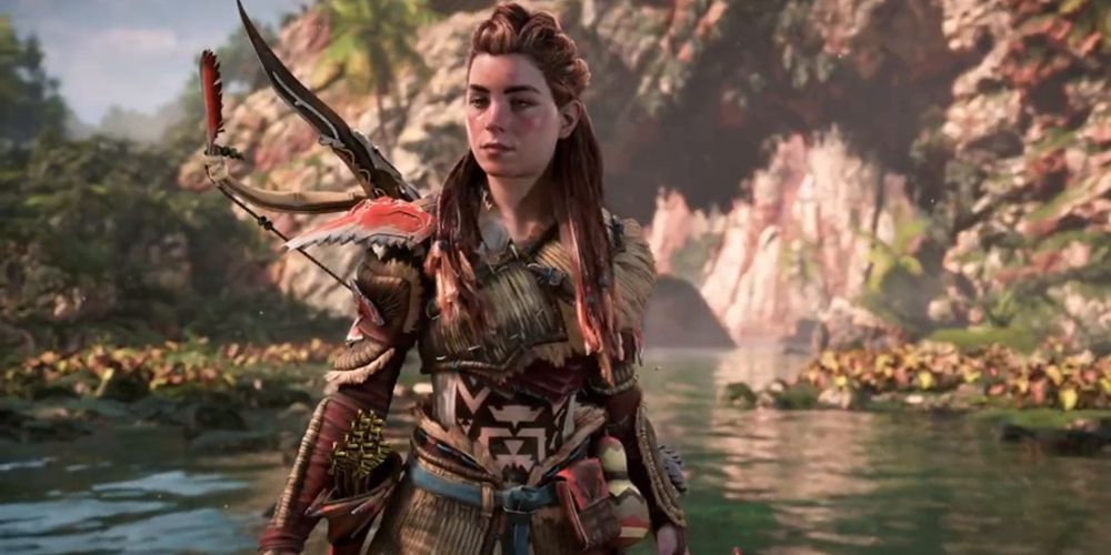 Aloy stands by a lake in Horizon Forbidden West