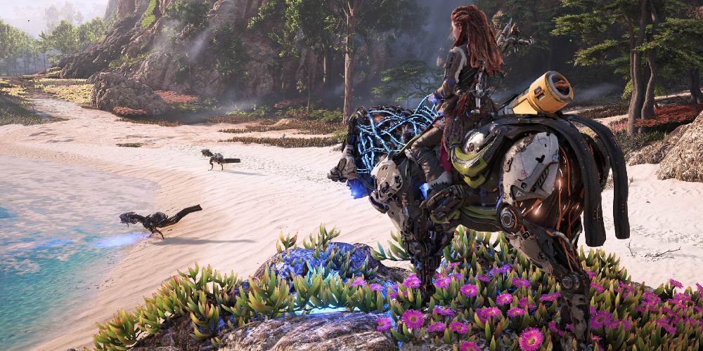 Aloy rests on a flowery cliff in Horizon Forbidden West