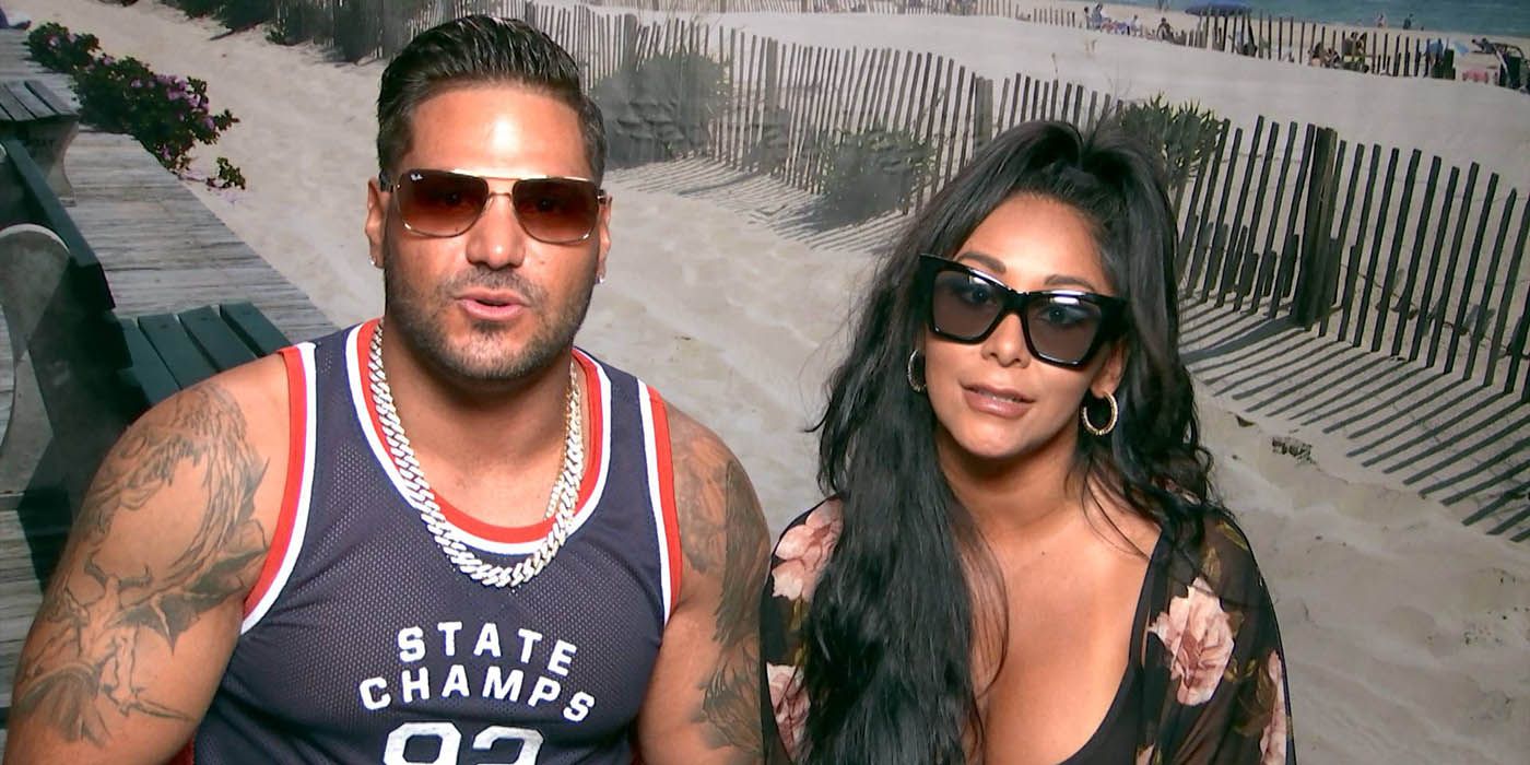 Ronnie and Nicole from Jersey Shore in the journal room, both wearing sunglasses.