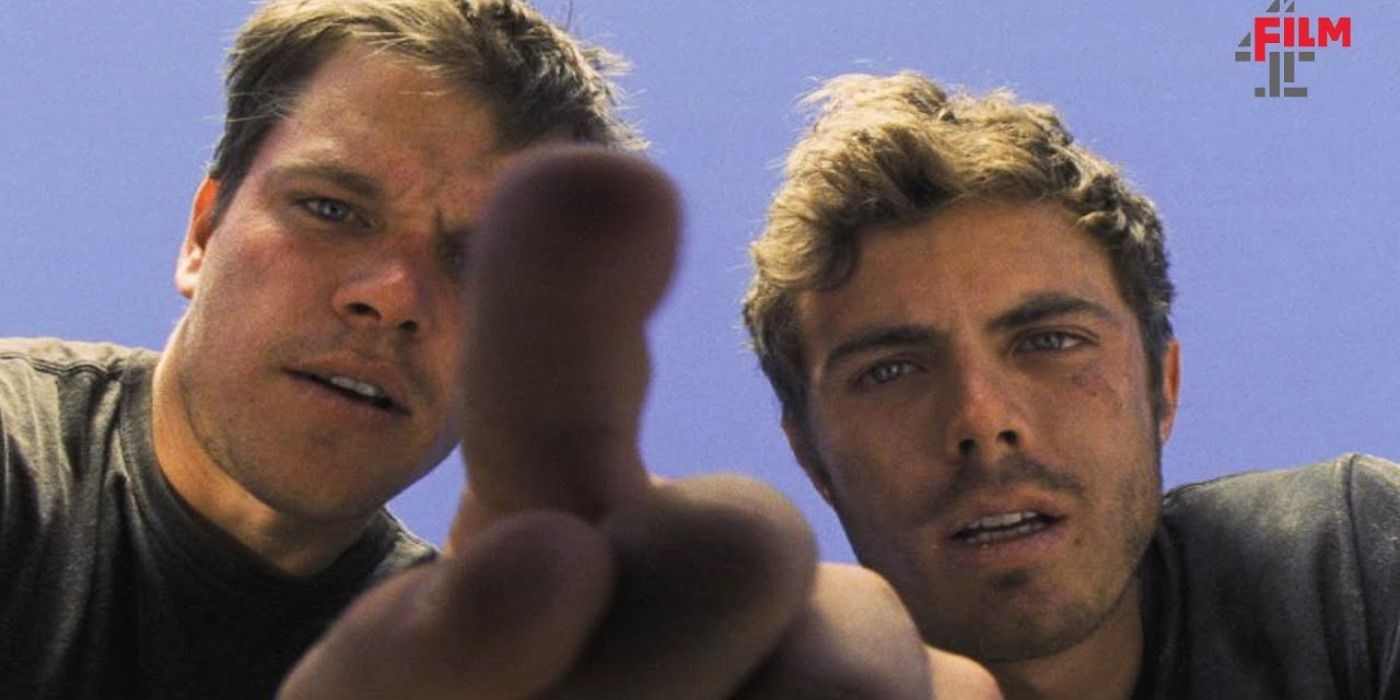 Matt Damon and Casey Affleck look down into a camera.