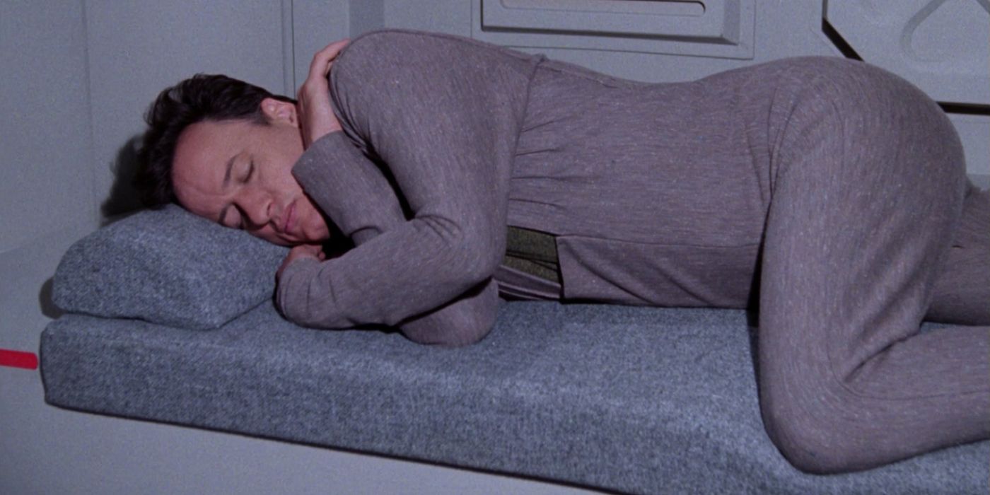 An image of Picard asleep on his bed in Star Trek